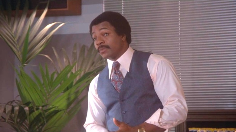 Apollo Creed standing in office