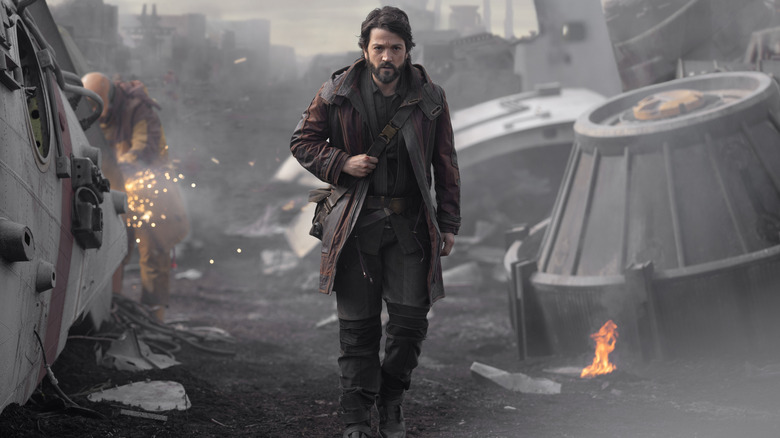 Cassian walking through demolition site 