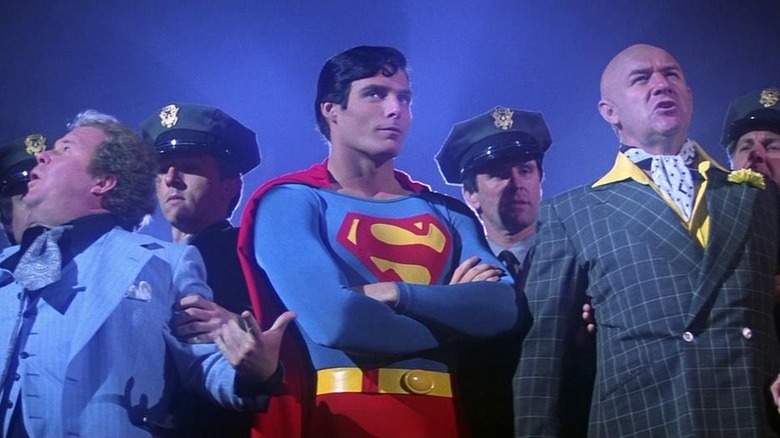 Superman standing with cops