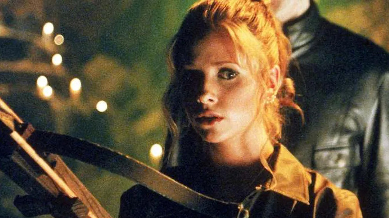 Sarah Michelle Gellar holding a crossbow