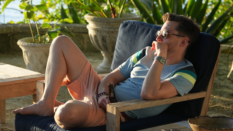 Roman lounging by pool