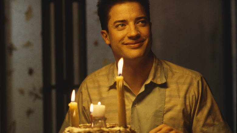 Brendan Fraser smiles with birthday cake