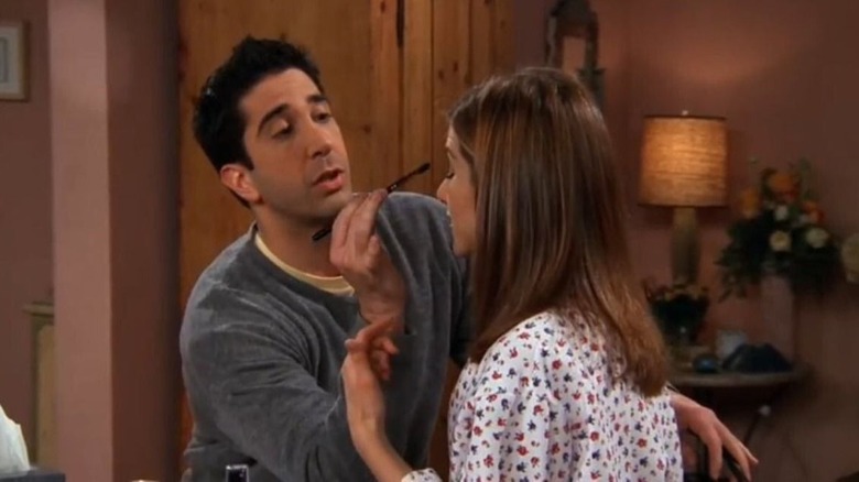 Ross applying makeup to Rachel