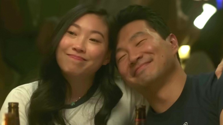 Awkwafina and Simu Liu hug