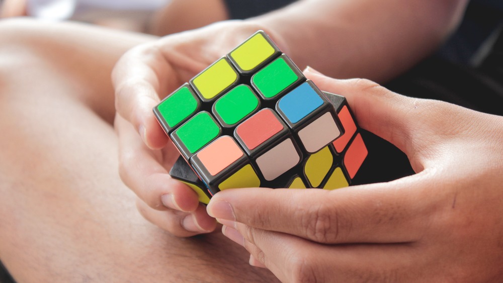 hands holding a Rubik's Cube