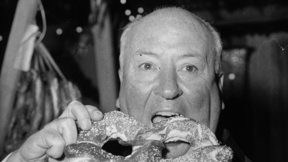 Alfred Hitchcock eating a pretzel