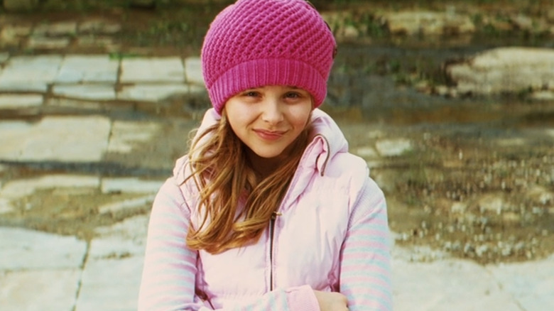 Mindy Mcready in pink hat smiling