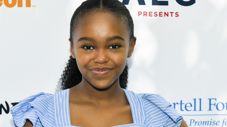 Lidya Jewett smiling against white backdrop