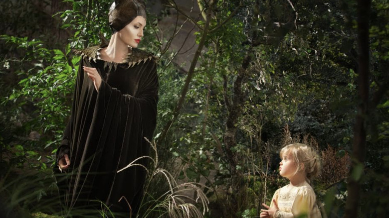 Maleficent and young Aurora in woods