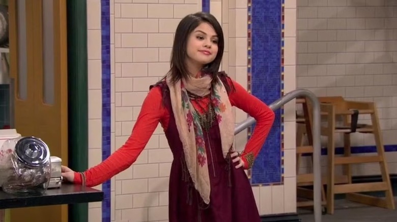 Alex leaning against a counter in "Wizards of Waverly Place."