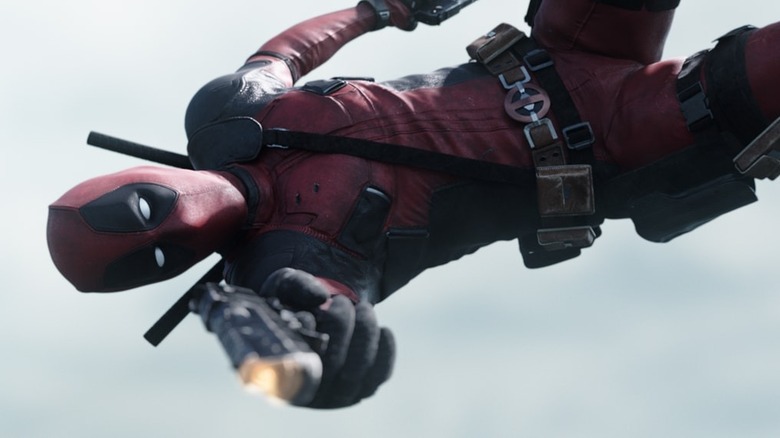 Deadpool shooting a gun mid-flip