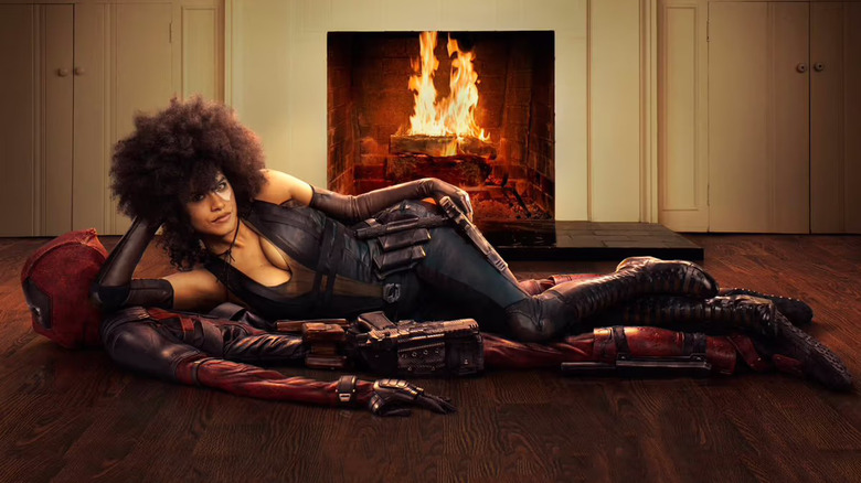 Domino laying on a Deadpool carpet