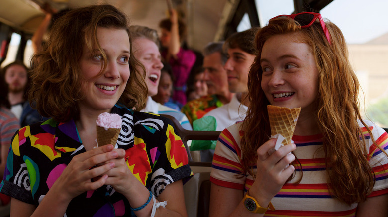 Eleven and Max eating ice cream on a bus in Stranger Things