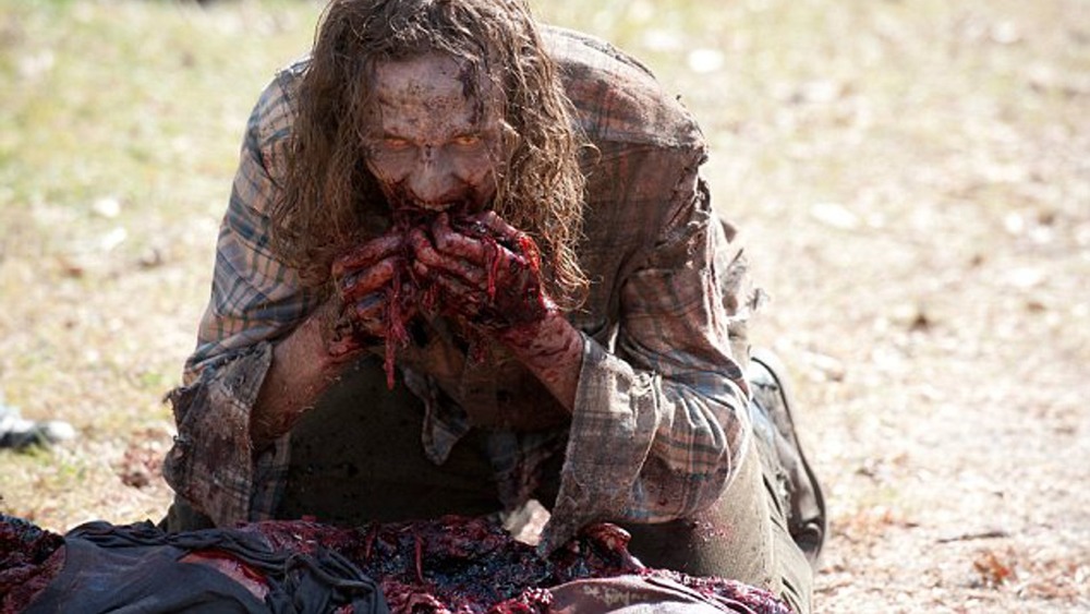 Walker eating bloody flesh