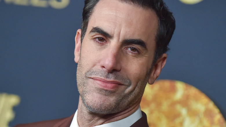 Sacha Baron Cohen smirking