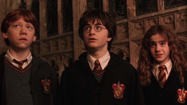 Harry, Ron, and Hermione wearing school uniforms