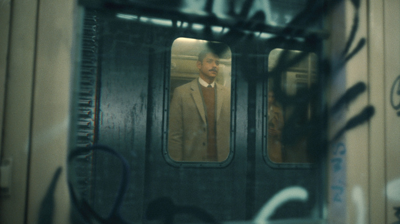 Alan in graffitied subway car