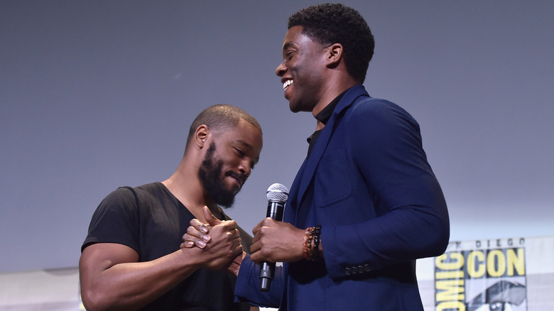 Director Ryan Coogler and actor Chadwick Boseman shake hands at San Diego Comic Con 2016