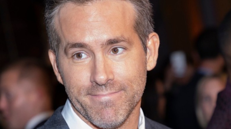 Ryan Reynolds smirks