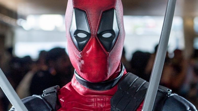 A cosplaying Deadpool poses