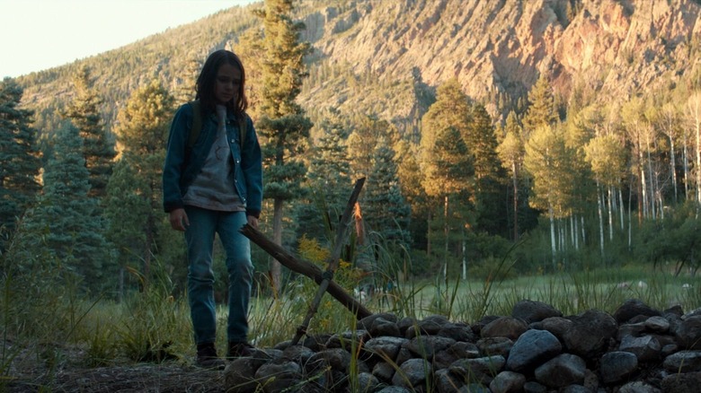 Laura looking at Logan's grave