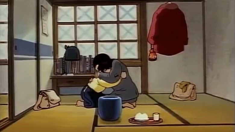 Kayoko and Kisaburo embracing tearfully