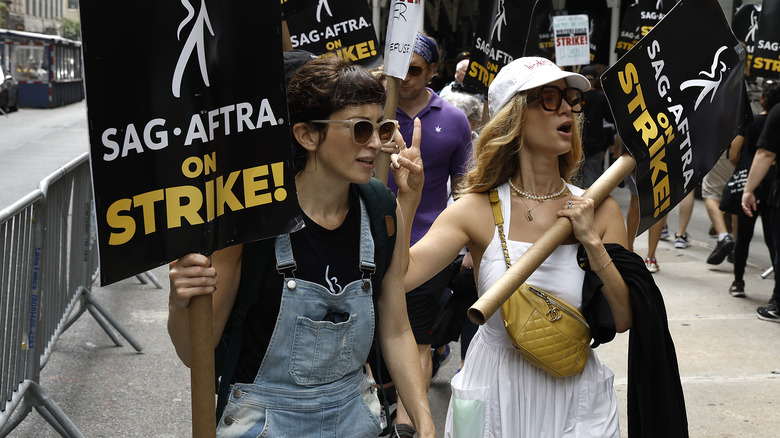 Picketers holding signs