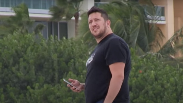 Sal Vulcano holding his phone and looking up