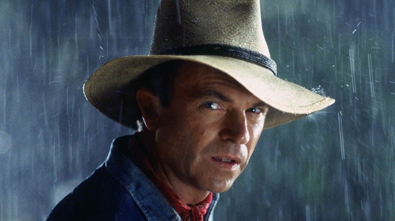 Sam Neill stands in the rain