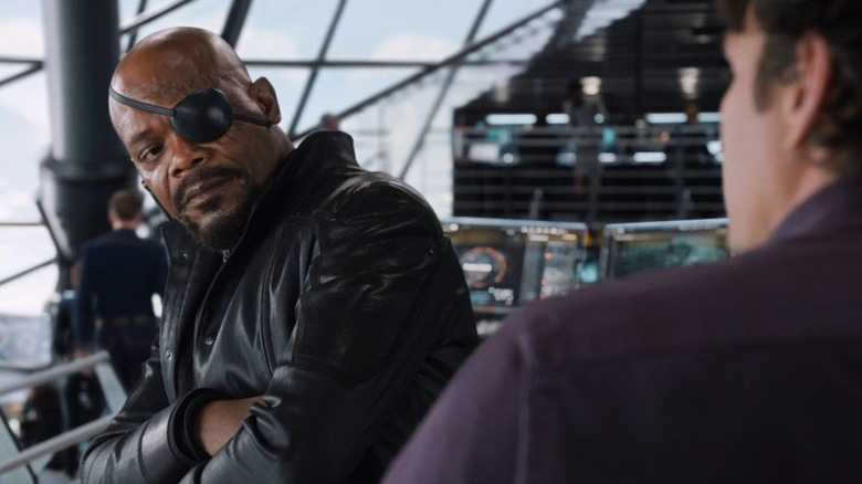 Nick Fury listens to Bruce