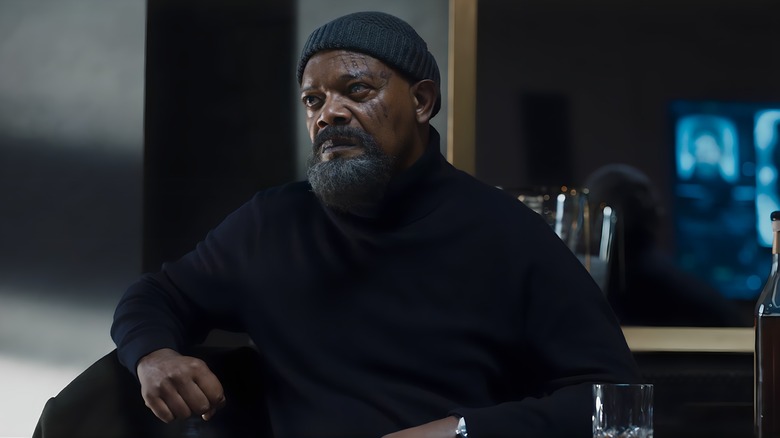 Nick Fury sitting at table looking angry