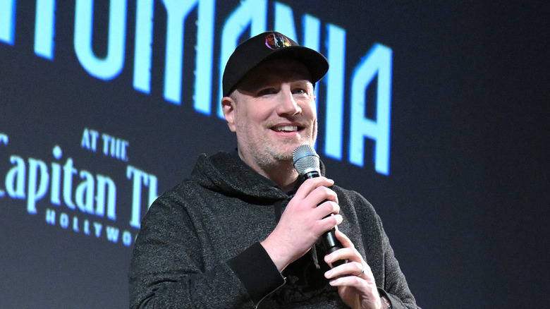 Kevin Feige holding a microphone