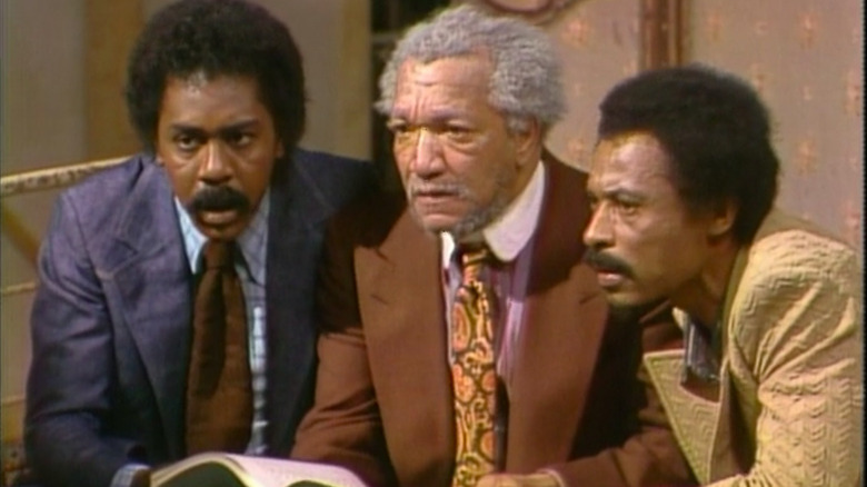 Lamont, Fred, and Rollo reading a script