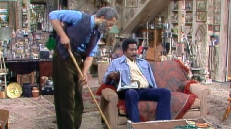 Grady cleaning around a sitting Lamont