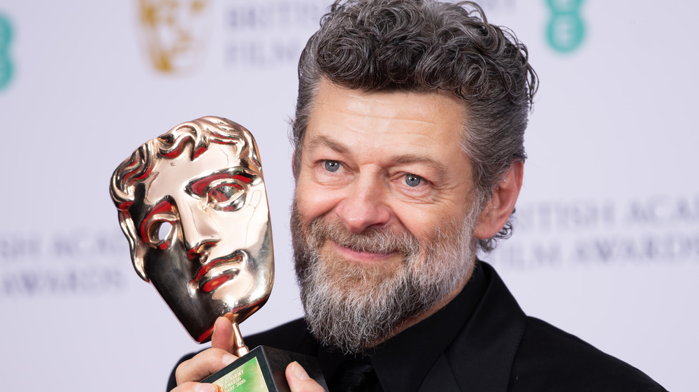 Andy Serkis holding award