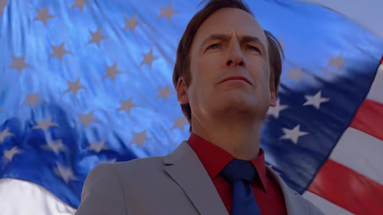 Jimmy McGill gazes proudly in front of a flag