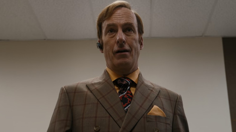 Saul Goodman talks on a Bluetooth headset 