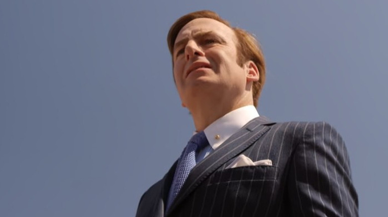 Jimmy McGill stands in front of a clear blue sky 