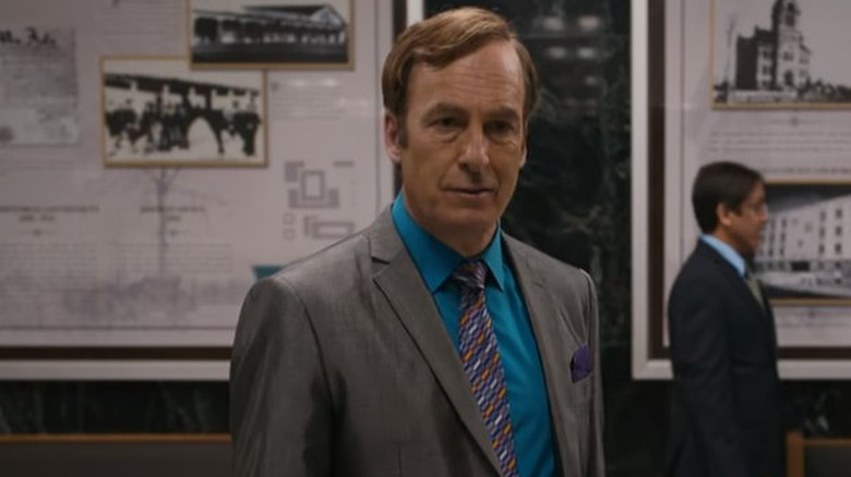 Saul Goodman stares ahead in front of a marble wall