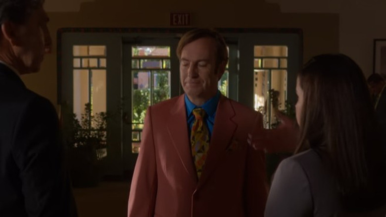 Jimmy McGill looks satisfied in a loud suit