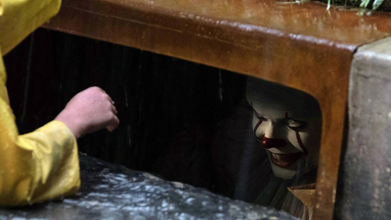 Pennywise smiling in the sewer