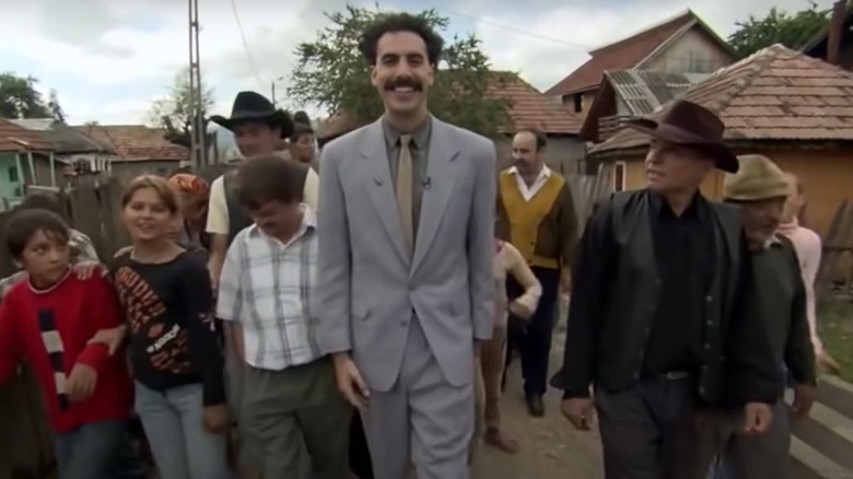 Borat walking with villagers