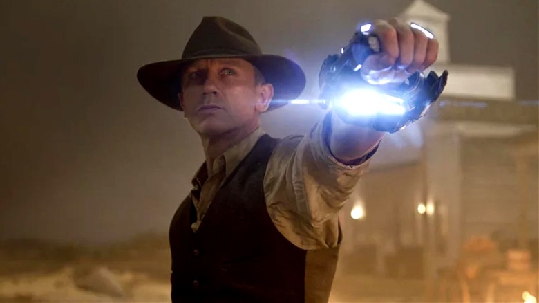 Jake Lonergan points his alien weapon in "Cowboys and Aliens" (2011)