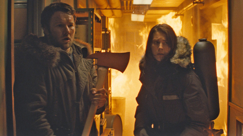 Sam Carter and Kate Lloyd evade a fire in "The Thing" (2011)