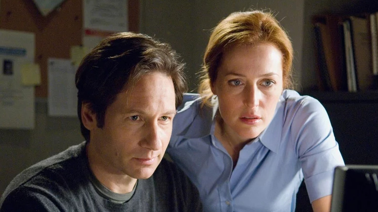 Fox Mulder and Dana Scully look over a computer screen in "The X-Files: I Want to Believe" (2008)