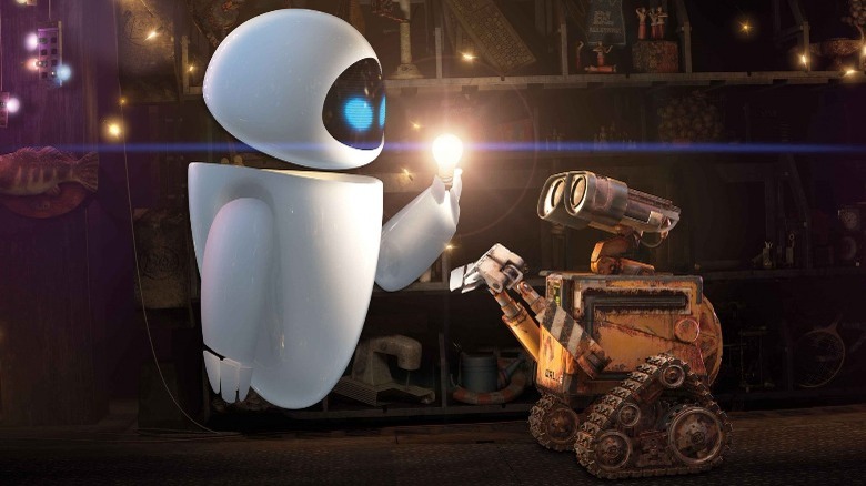 Eva and Wall-E look at a light bulb