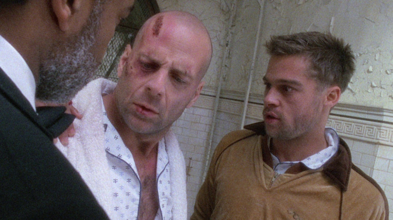 Brad Pitt staring at disheveled Bruce Willis