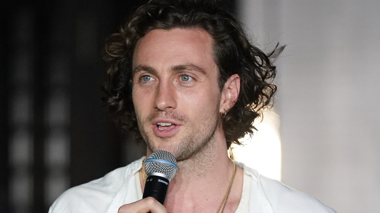 Aaron Taylor-Johnson speaking into a mic