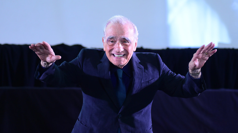 Martin Scorsese greets the audience at a theater