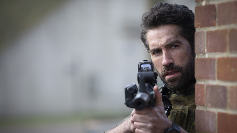 Scott Adkins pointing a gun as Jake Harris in One Shot